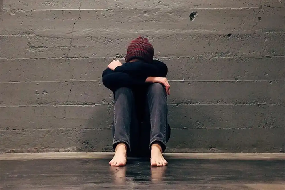 sad lgbtq member sitting on the floor