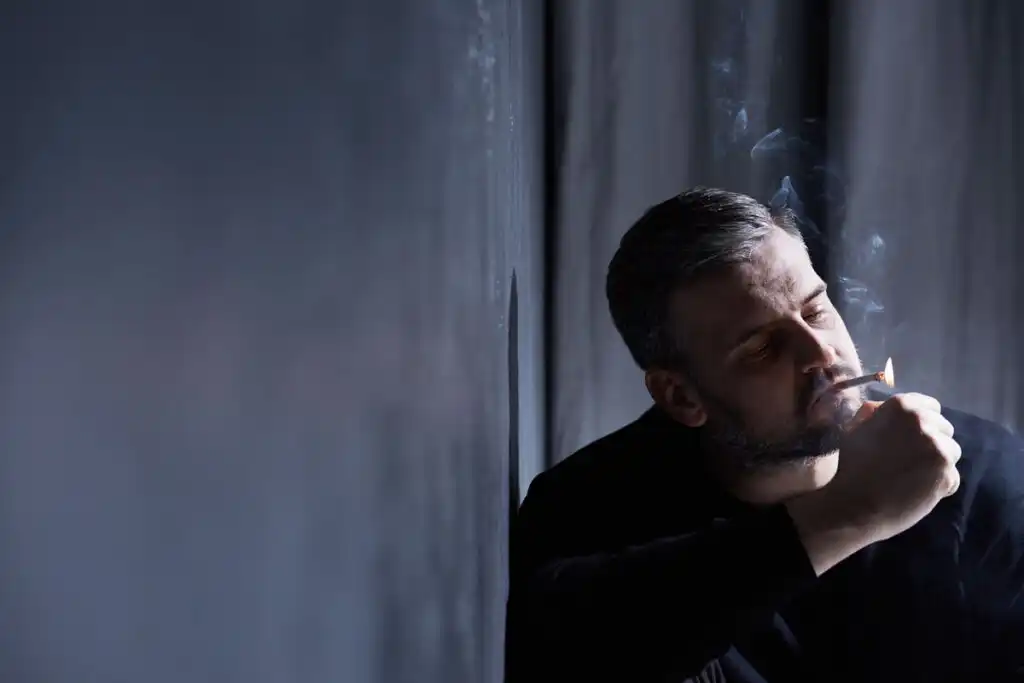 man alone smoking weed