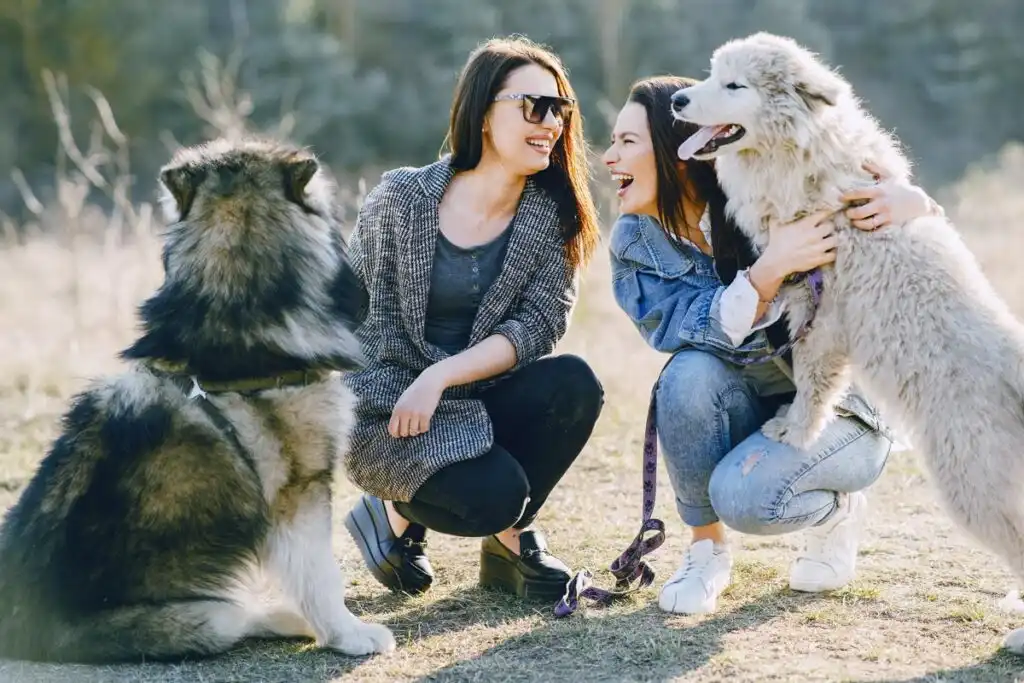 two women with their dogs