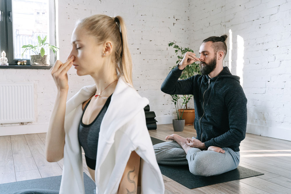 a man and woman doing breathing exercises