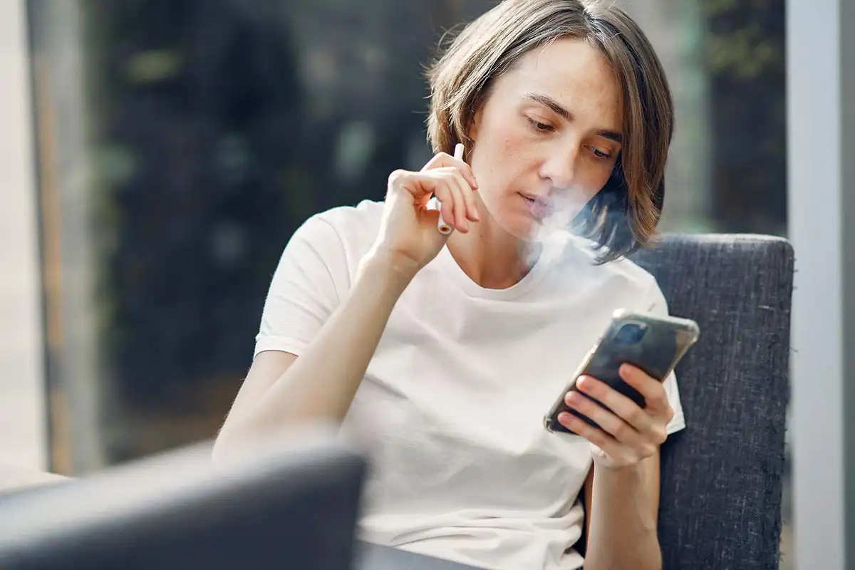 a woman using wax pen vaping device addiction