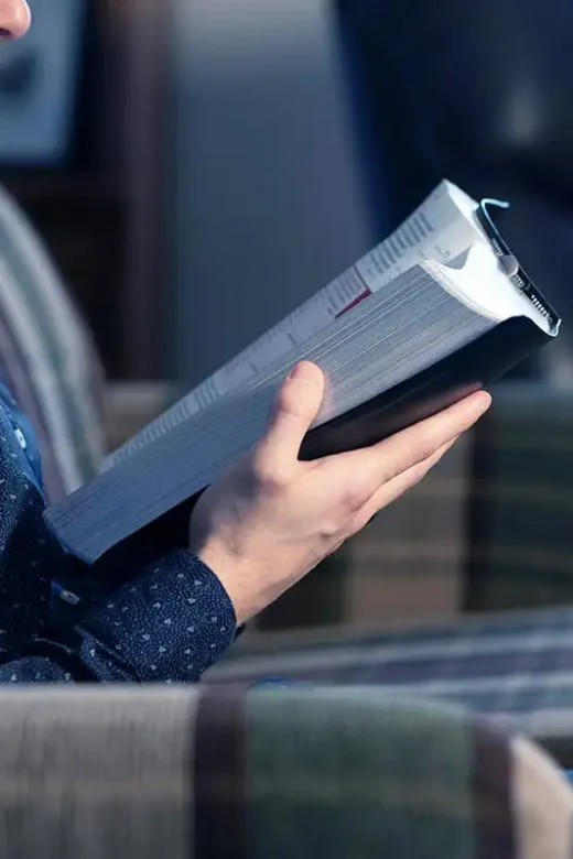a man recovering from addiction reading his Bible