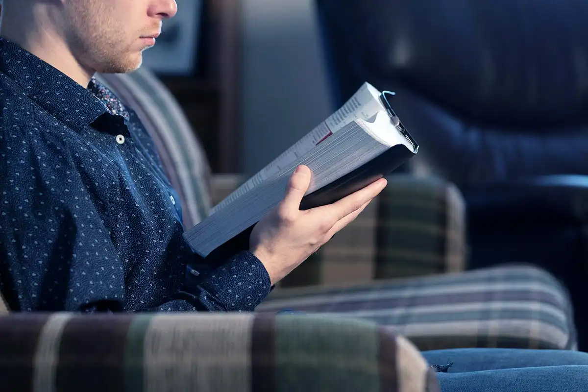 a man recovering from addiction reading his Bible