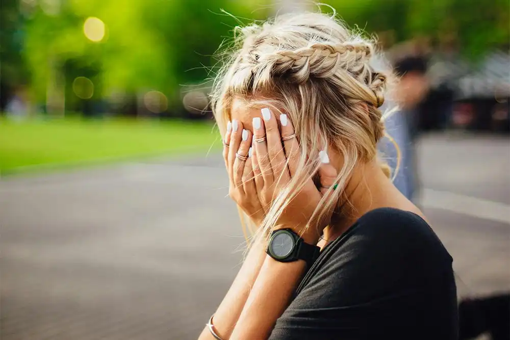 a woman feeling anxious because of many people in Riverside California