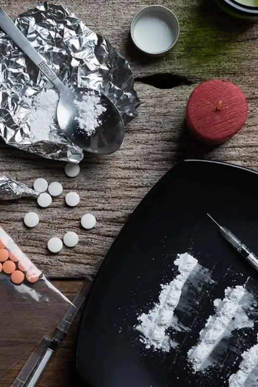 alcohol, drugs, pills on a wooden background