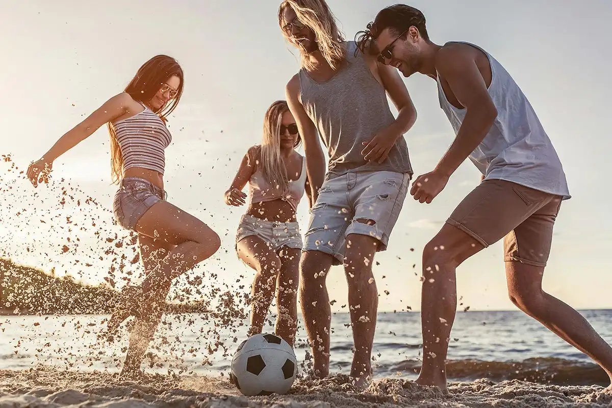 men and women playing soccer in the beach california