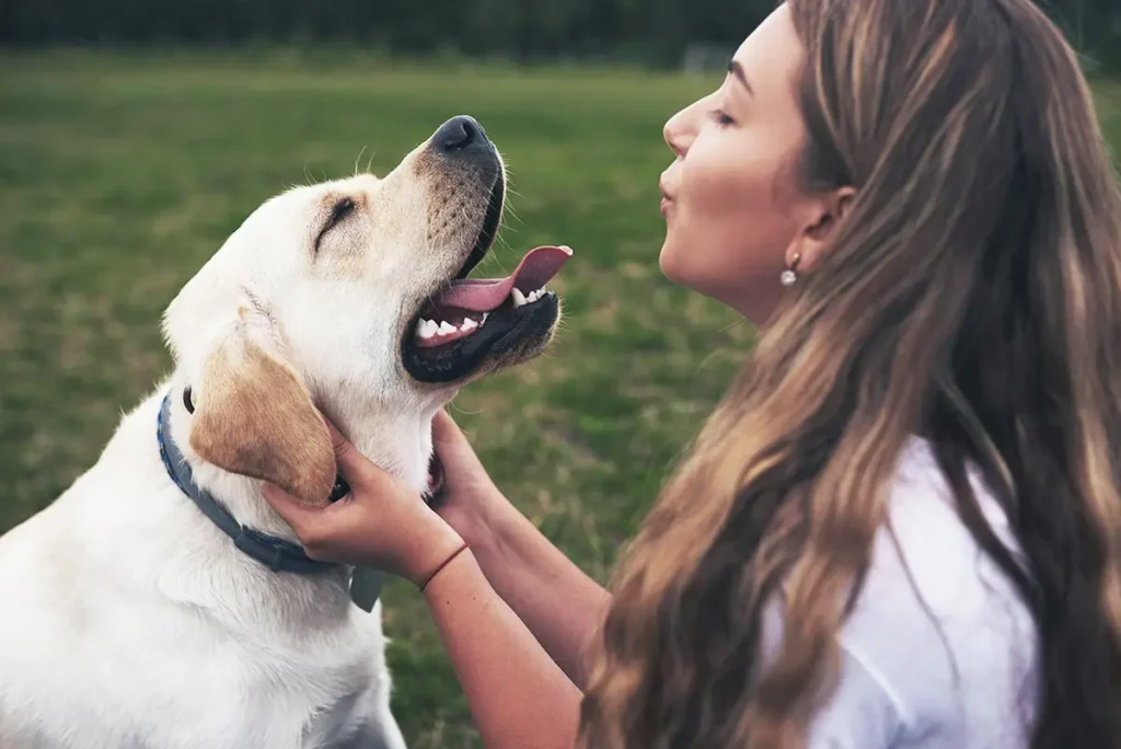 a female client playing with her dog at a pet friendly rehab