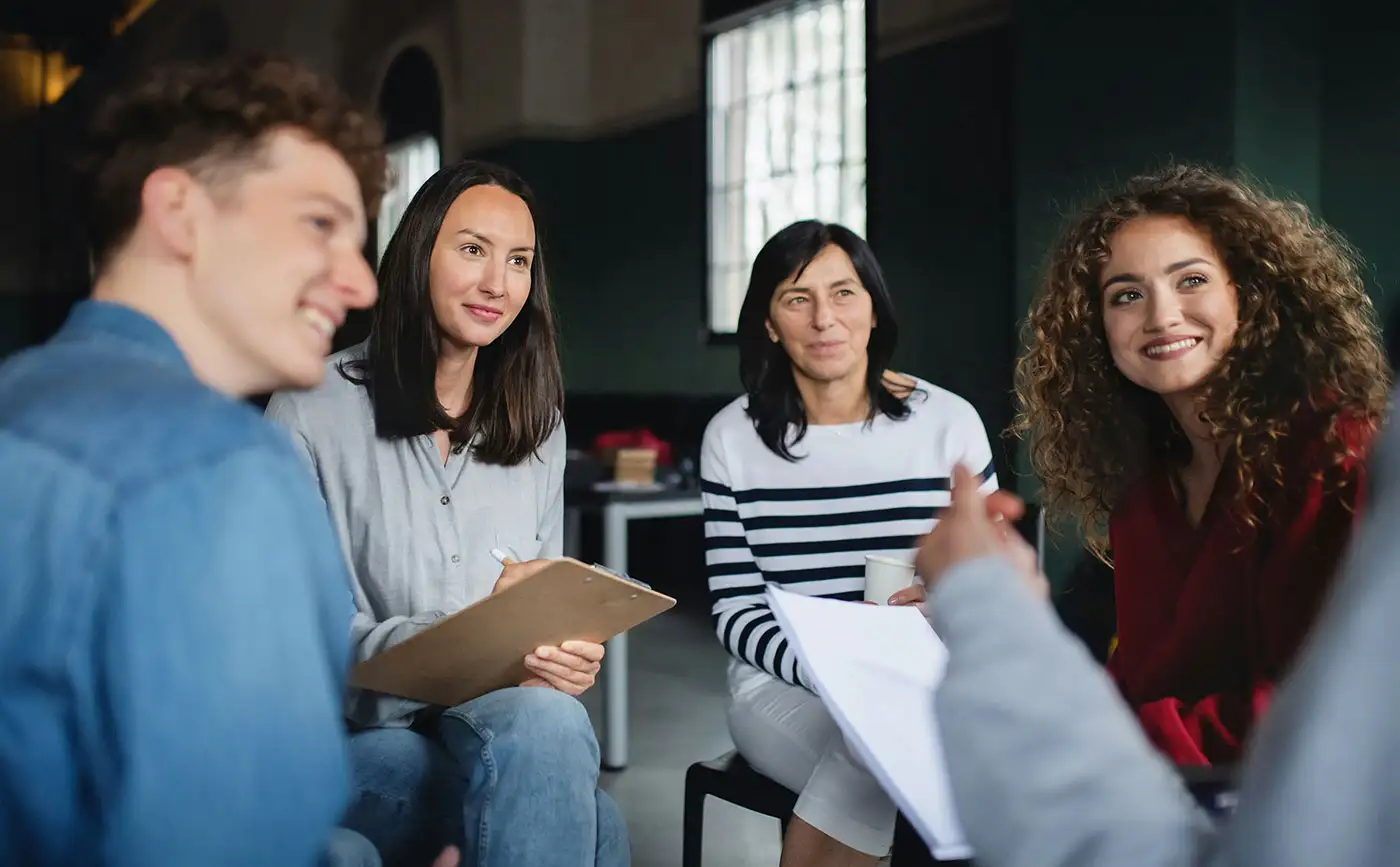 A group of individuals engaged in conversation during Percocet addiction treatment