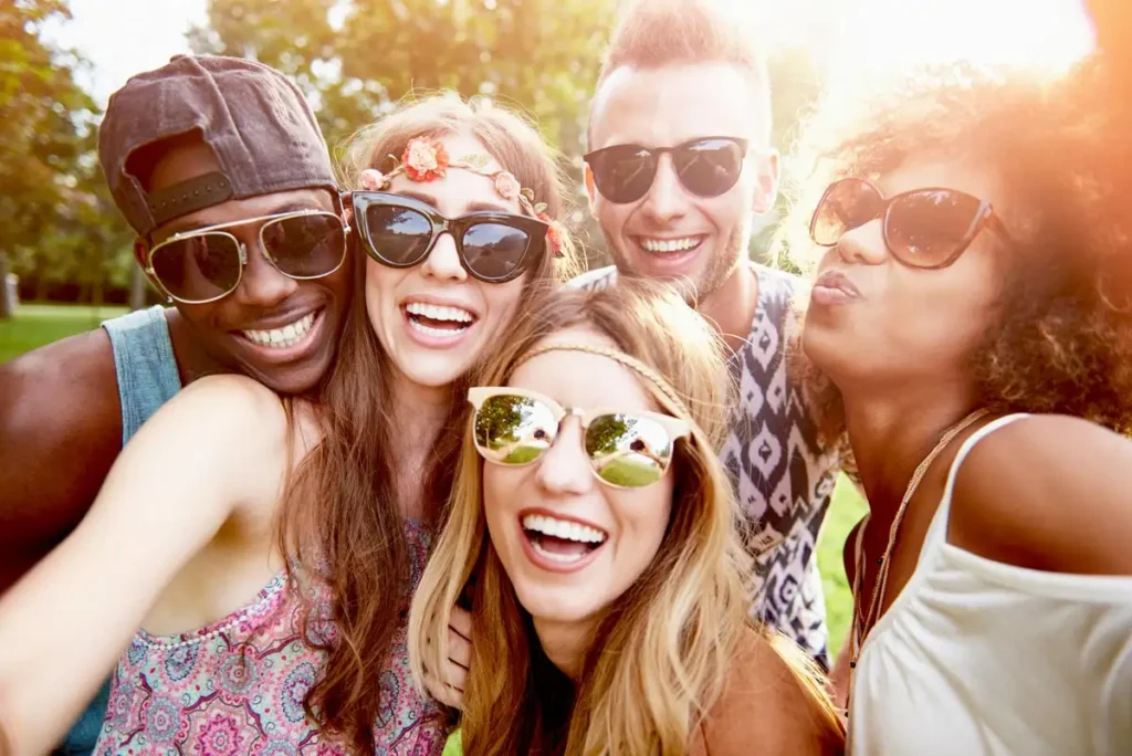  A group of young individuals smiling and posing together for a selfie, capturing a moment of joy and friendship