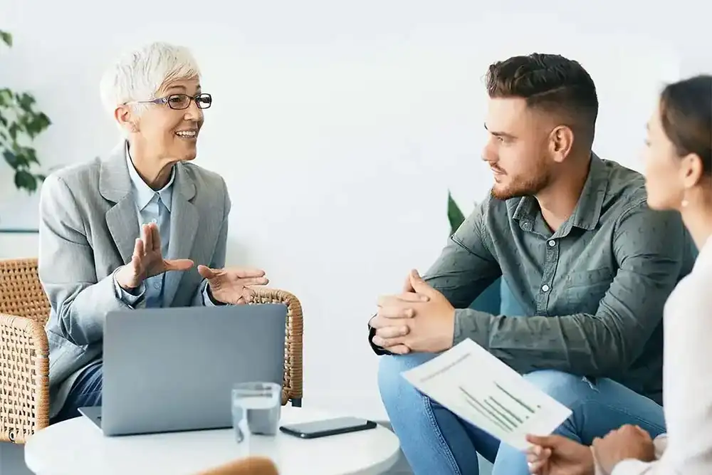 A man and woman engage in conversation with a psychotherapist during one on one counseling focused on drug detoxification program