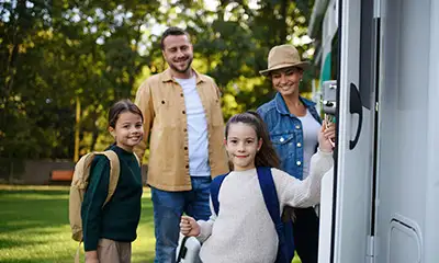 A supportive family near their RV, representing the importance of family therapy in overcoming challenges in drug rehabilitation