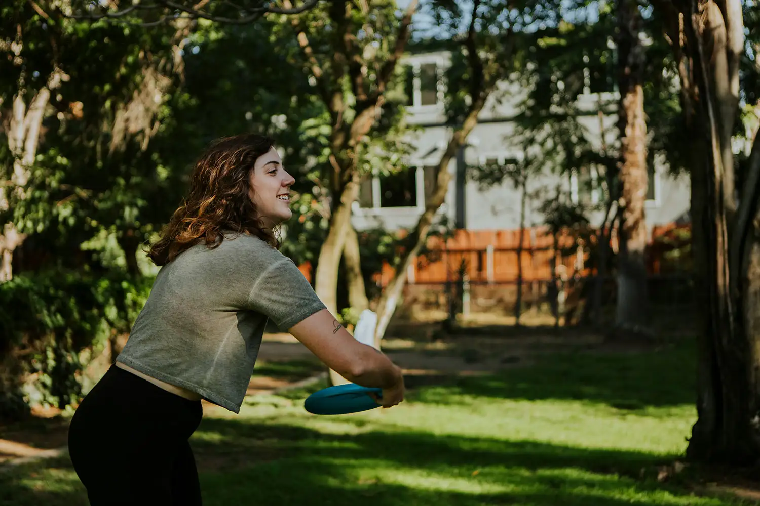 A woman joyfully throws a frisbee in alcohol rehab los angeles california