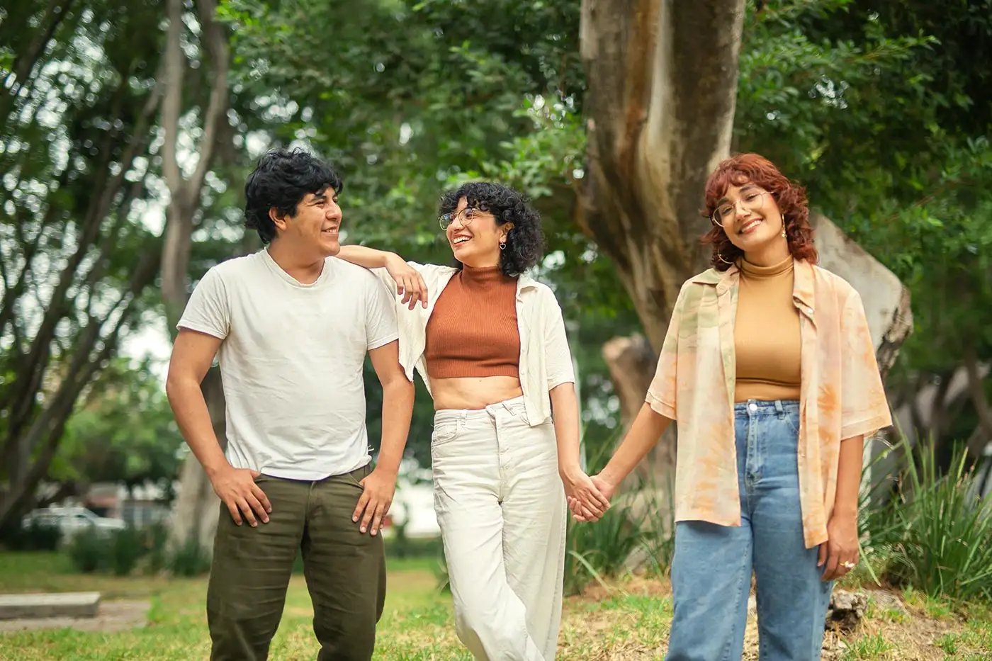 Three young individuals stroll through a park, symbolizing hope and recovery in the context of OxyContin addiction treatment.