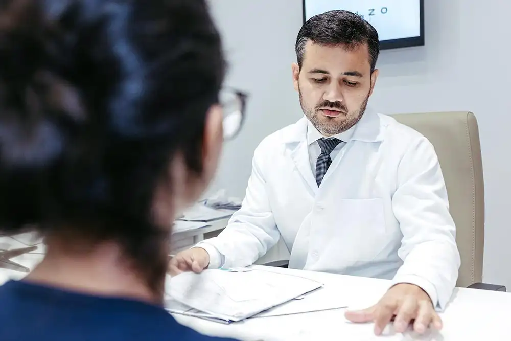 a male doctor explaining the Detox Program in riverside to a female client