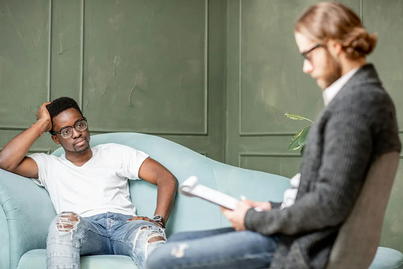 a man wearing white shirt listening to his therapist during a personality disorder treatment in Los Angeles California