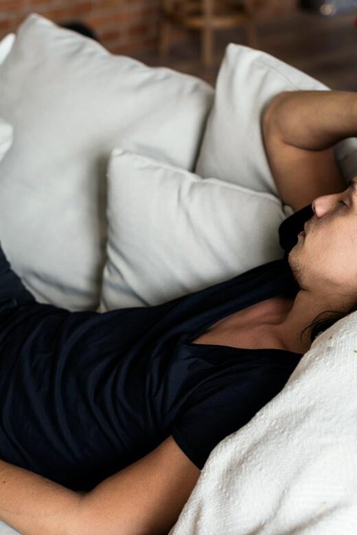 a man with hangover lying in the sofa