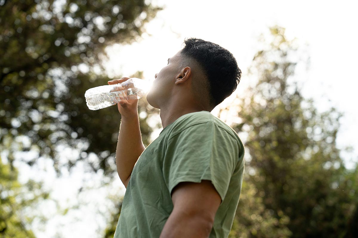 man hydrating himself after a hangover