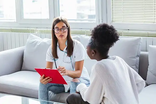 a female client with her psychologist during trauma focused therapy