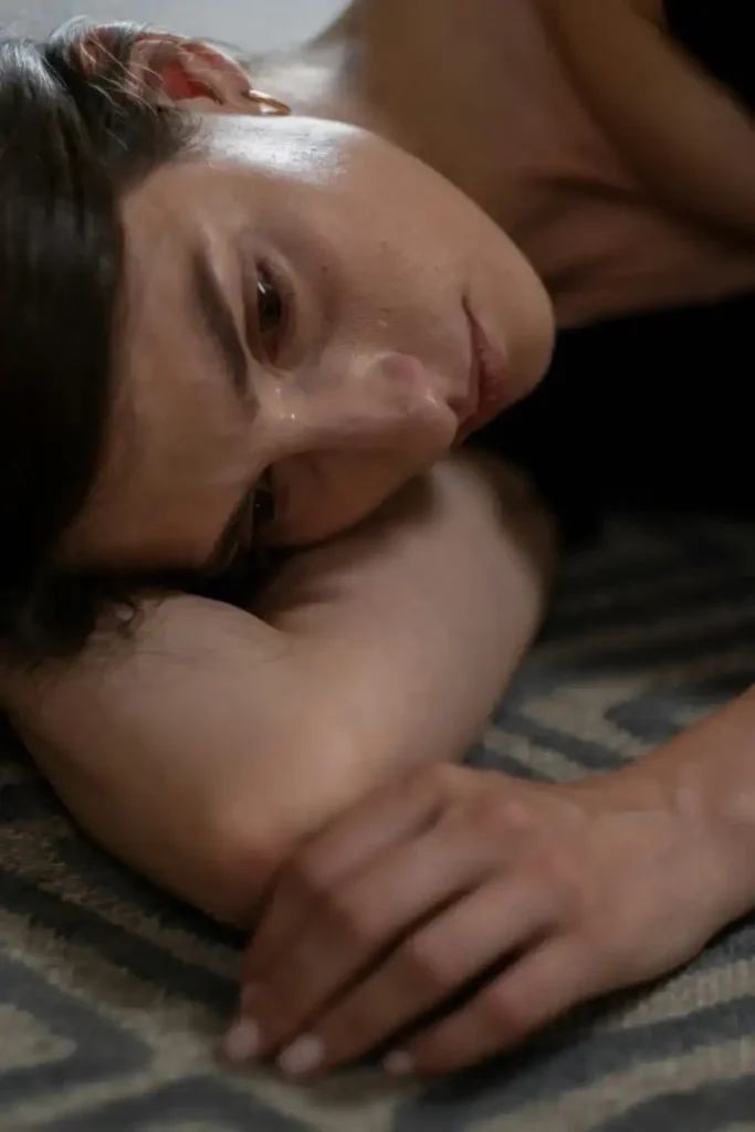 sad woman lying in bed depressed addiction treatment center in Riverside CA