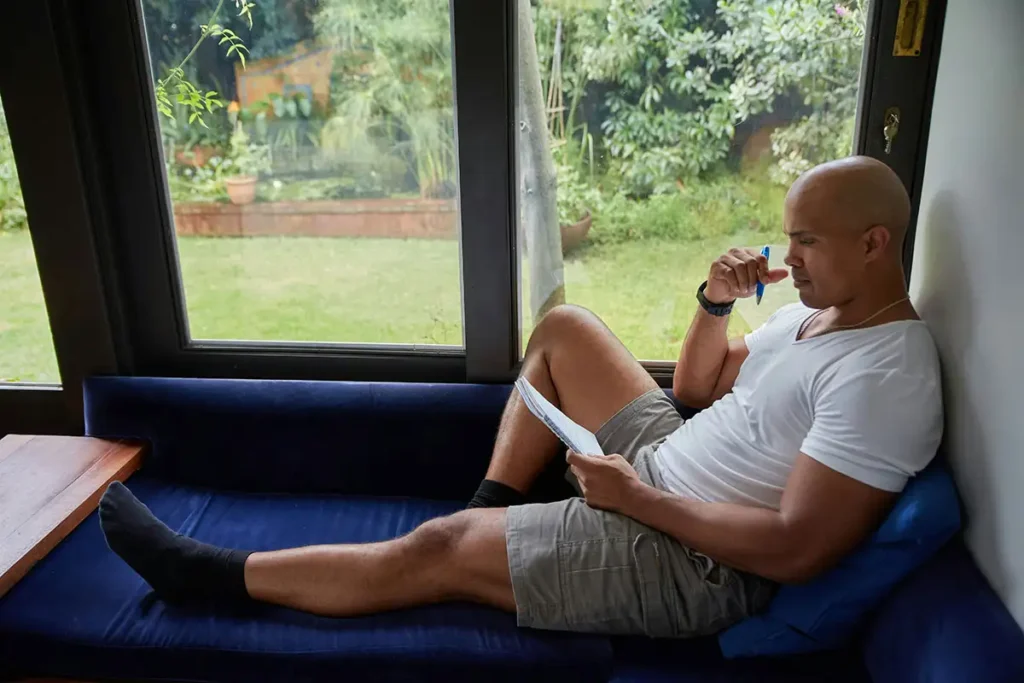 man writing journal about his recovery