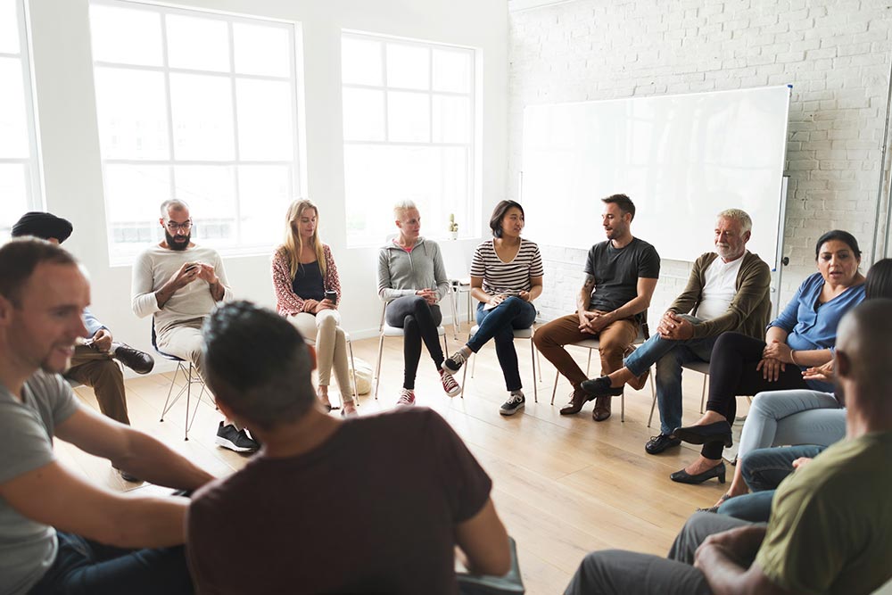 men and women during group therapy