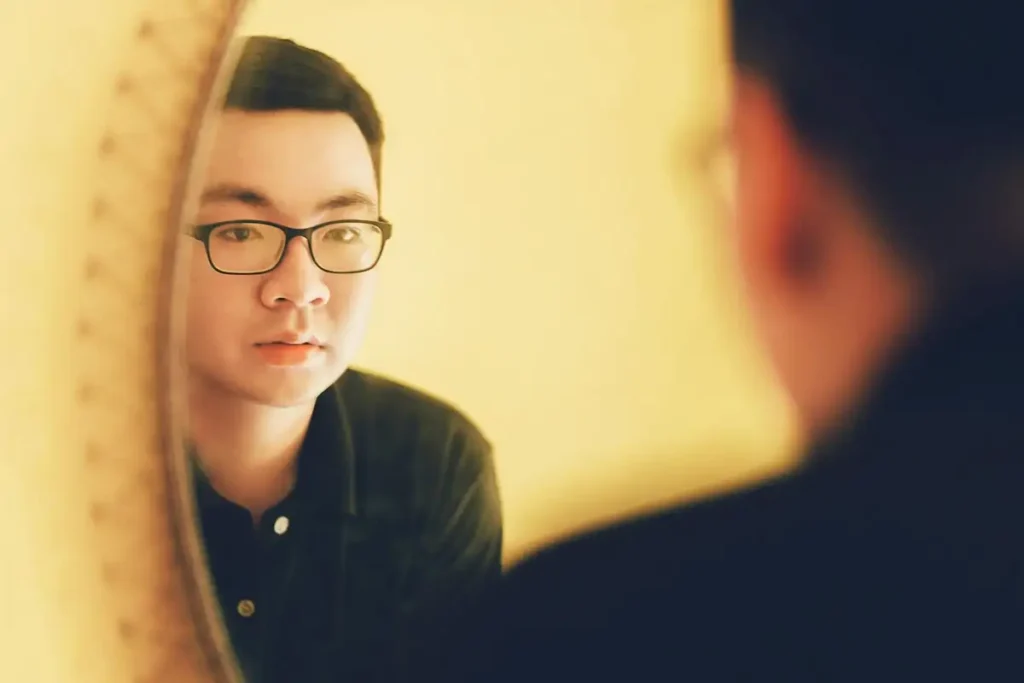 Man Looking In Mirror