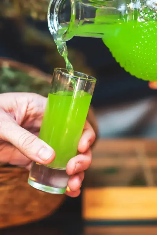 Man Pouring Himself Some Homemade Cannabis Liquor
