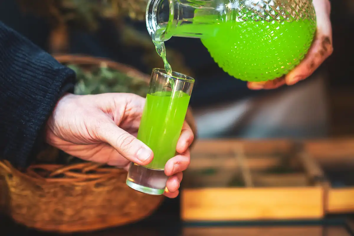 Man Pouring Himself Some Homemade Cannabis Liquor