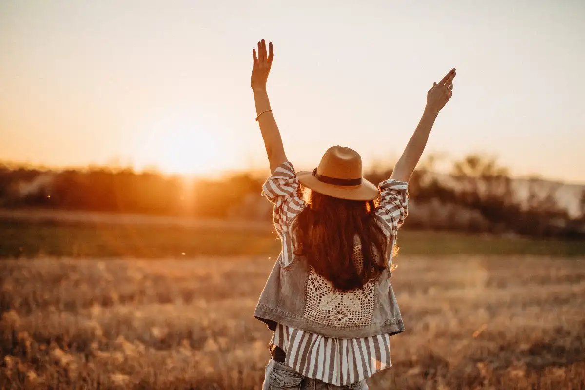 Peaceful woman having fun in meadow