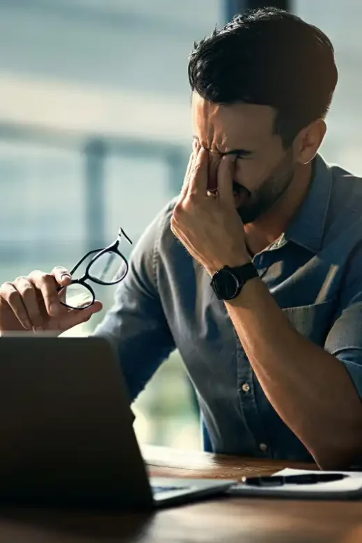 man stress at work, frustrated in front of his laptop