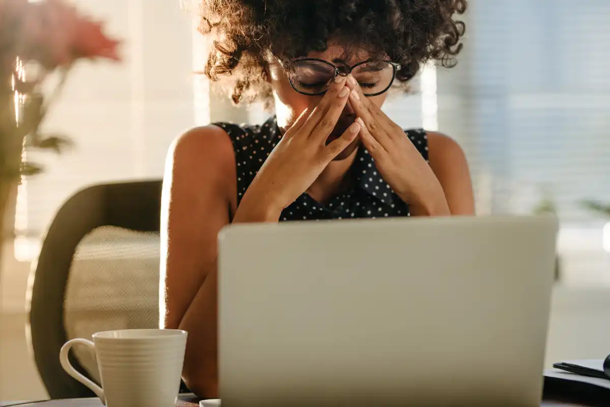 woman stress at work, frustrated in front of her laptop