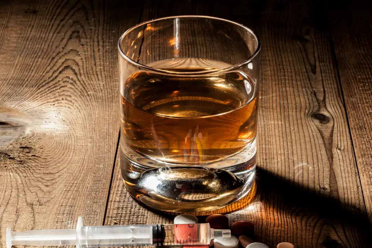 Alcohol and drugs in the wooden table