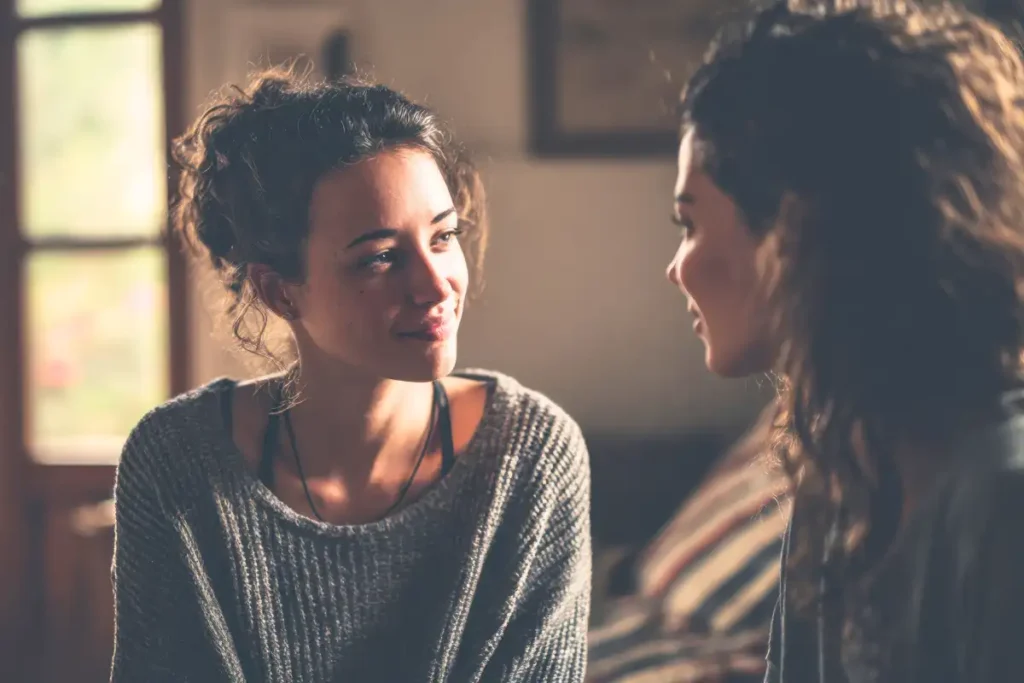 Two women having warm conversation in cozy home atmosphere