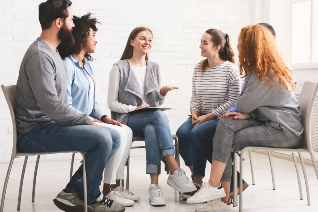 men and women in a group therapy