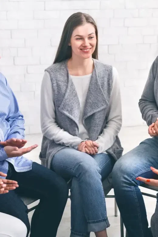 Community Members Applauding To Mentor At Session In Rehab