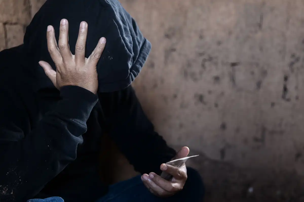 Man Holding Plastic Packet of Drugs