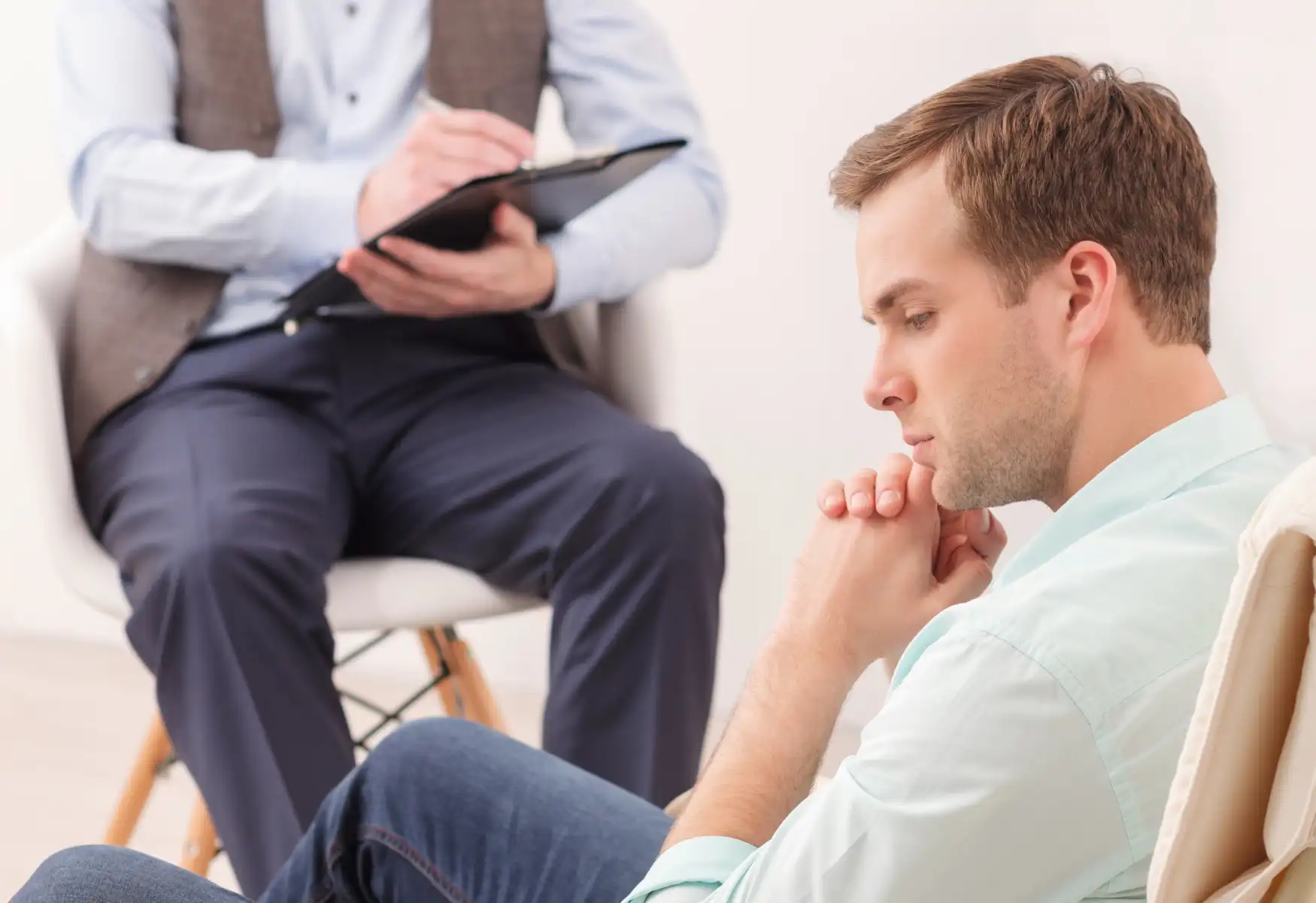 Handsome guy sharing problems with psychotherapist