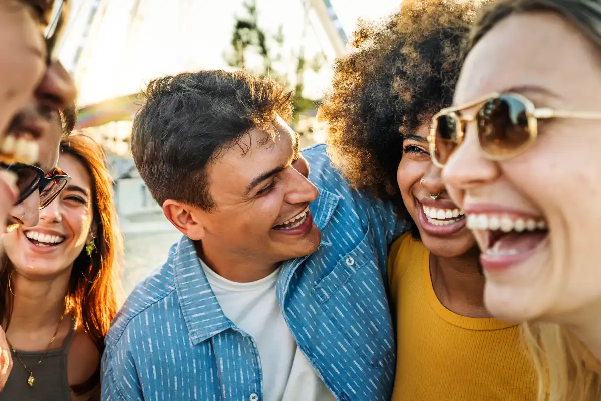 Multiethnic young people laughing together outside - Friendship