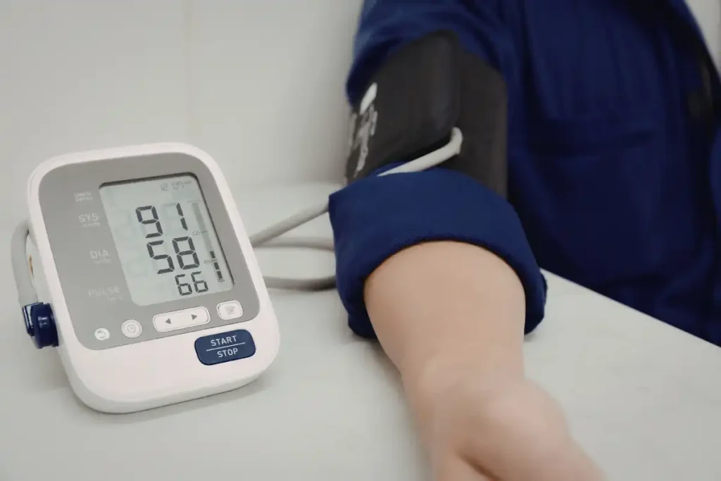 Person monitoring blood pressure with device
