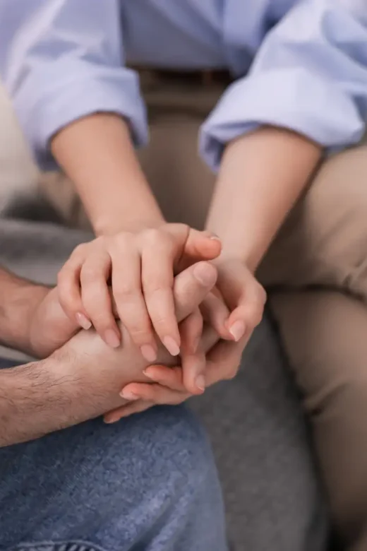 Psychologist Supporting Patient during Session on Sofa in Office