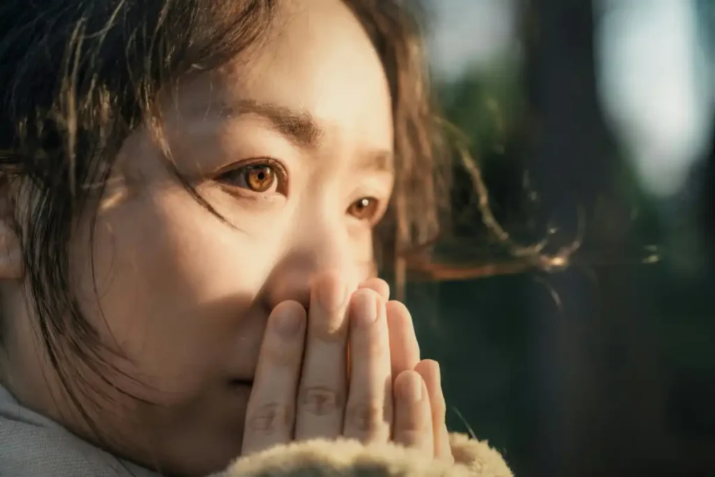 Thoughtful Woman Embracing Sunlit Nature