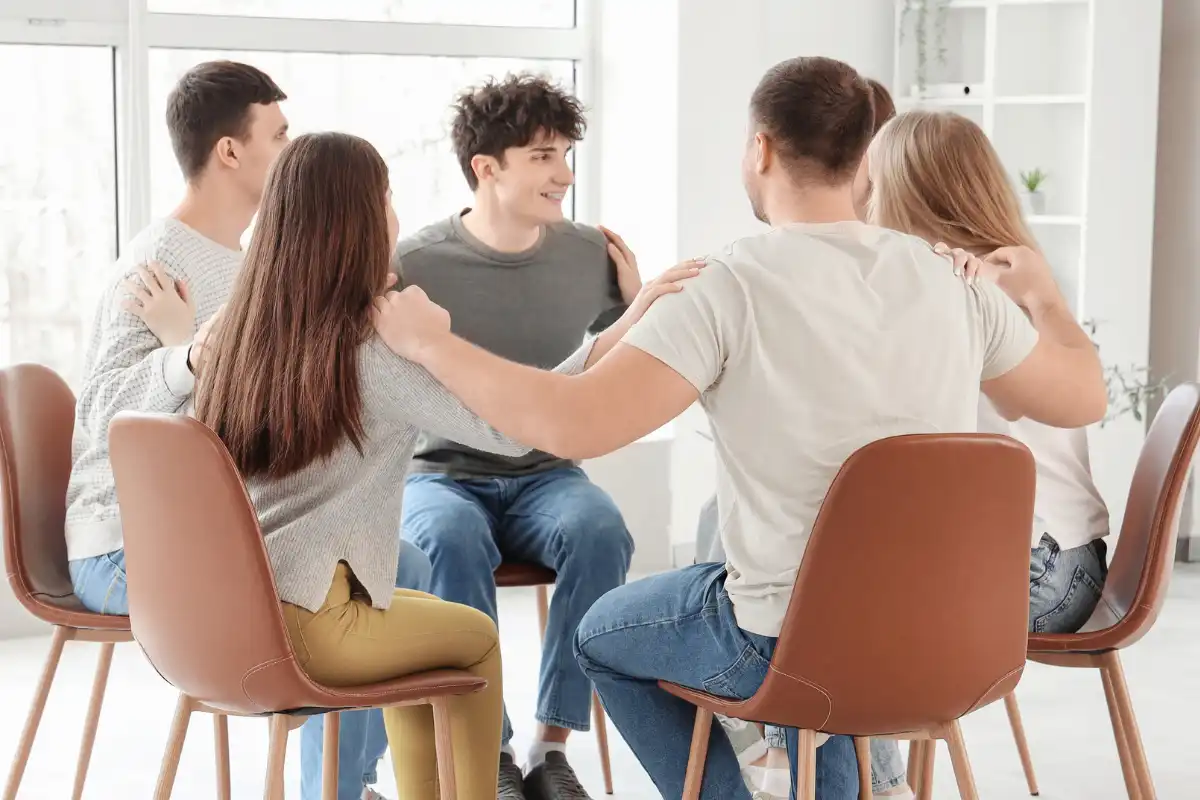 Young People Hugging at Group Session