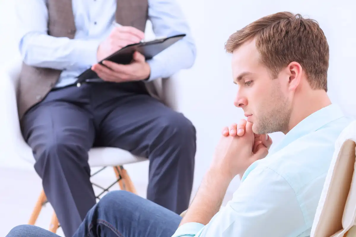 a male client sharing problems with psychotherapist