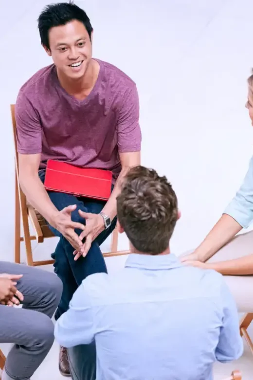 men and women during group therapy at residential treatment