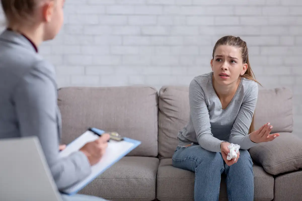 Psychological help service. Depressed female patient having psychotherapy session with counselor at office