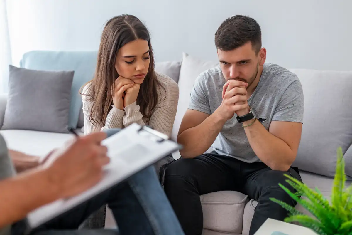 Young couple having marriage counseling in drug and alcohol treatment center