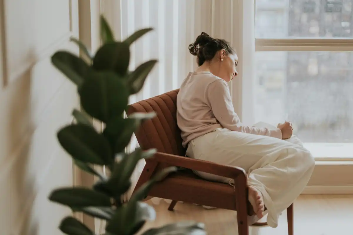 Contemplative Woman Relaxing by Window
