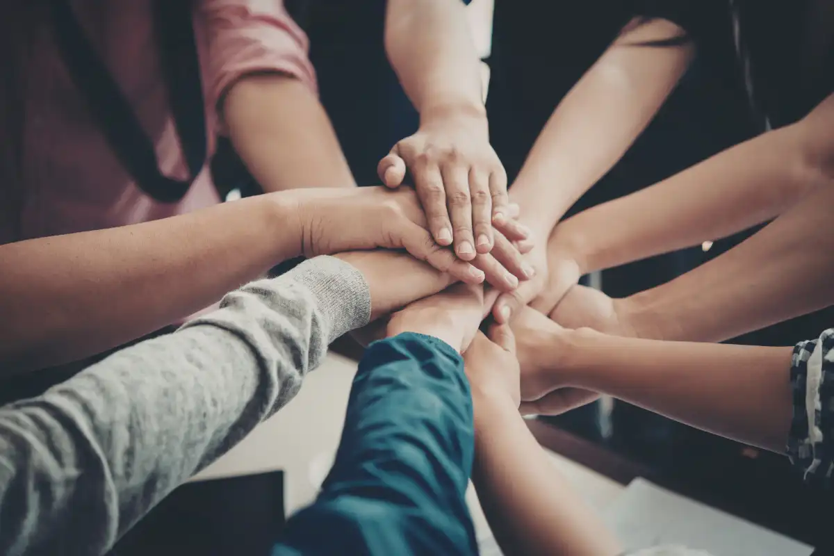 People joining hands in unity