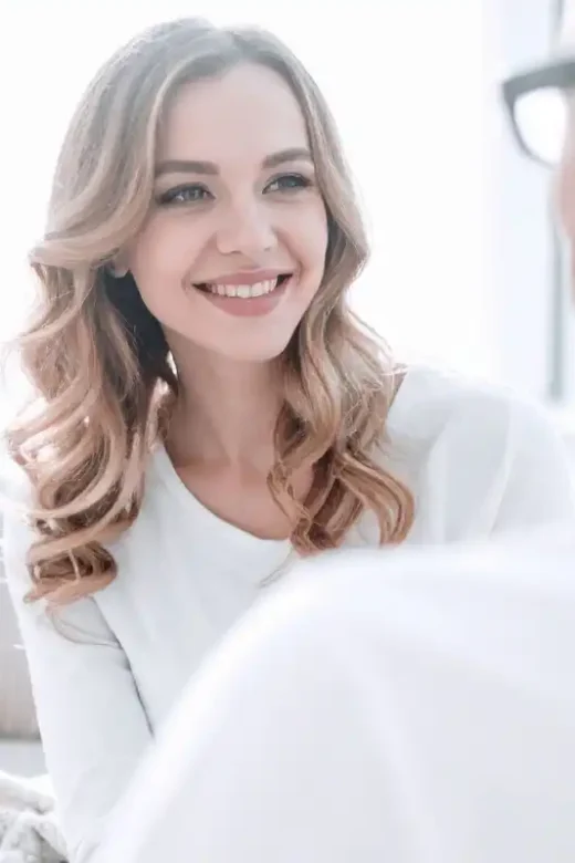 Smiling Couple Talking on Couch Indoors