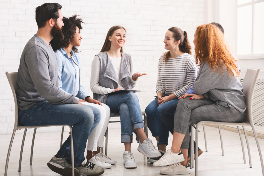 men and women during group therapy in a residential rehab